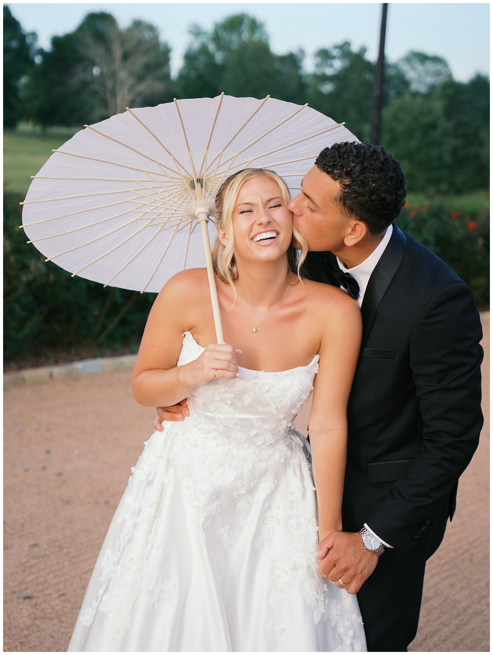 bride and groom wedding photo with parasol at their Blackberry ridge wedding